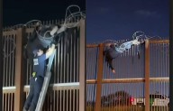 Atrapado migrante en alambrada de púas de muro fronterizo