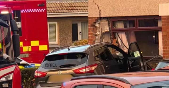 Car smashes into home in busy town as police tape off street