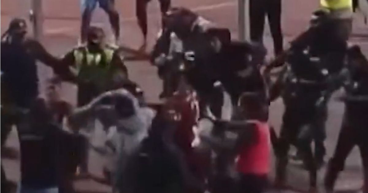 Chaotic football brawl sees 17 sent off in violent scenes as police fire tear gas