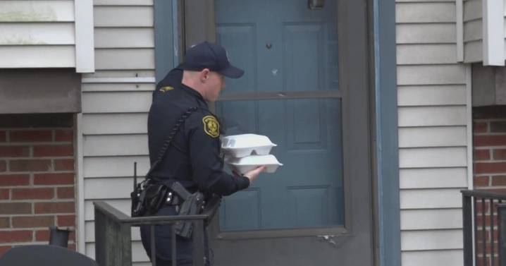 Police officers in Pittsburgh pass out Thanksgiving meals to those in need