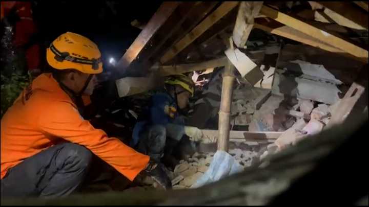 Rescue teams search at scene of Indonesia landslide