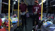 Alabama A&M students stuff a bus full of Christmas presents