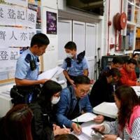 Grieving Hong Kong families search stark photos for fire victims