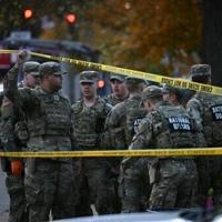 US halts asylum decisions as troop killing sparks migrant crackdown