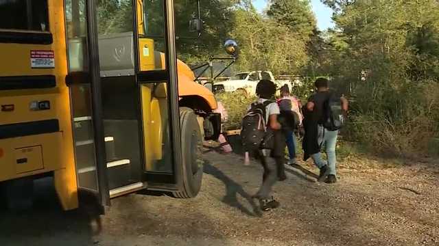Students told to climb under train car at bus stop in Alabama