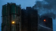Hong Kong fire that killed at least 65 burns for a second day