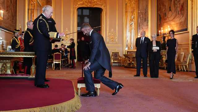 Bend a knee like Beckham: Soccer star is knighted by King Charles III