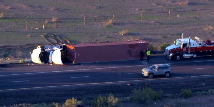Driver hospitalized after semi-truck rollover on I