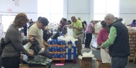 Community gathers to fill food boxes for families in need