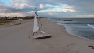 Stranded sailboat on Jersey Shore beach causing safety concerns