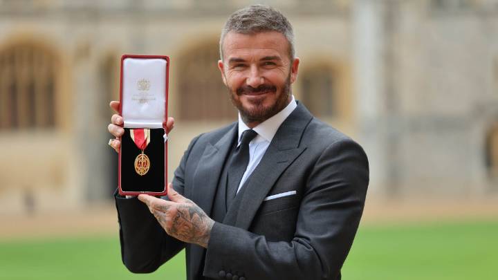 Bend a knee like Beckham: Soccer star is knighted by King Charles III