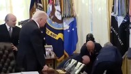 Man faints next to Trump's White House desk