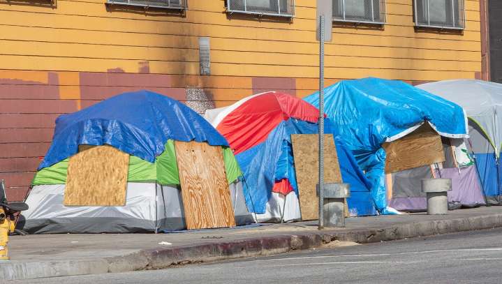 Californians Prepare For Hurricane By Nailing Plywood Boards Onto Their Tent Flaps