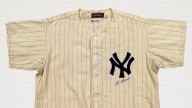 Yogi Berra's rookie jersey, perfect game pants top $550K at auction
