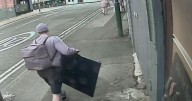 Burglar caught red-handed carrying huge stolen TV down street in broad daylight