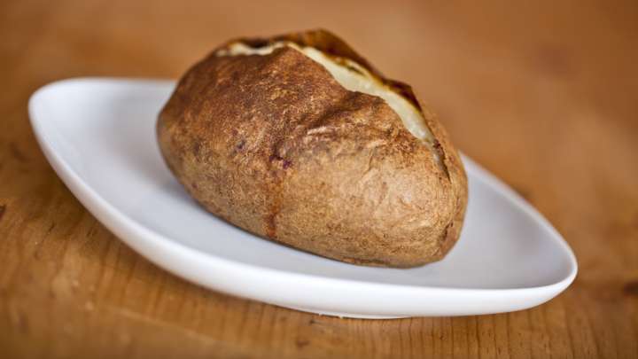 The British Baked Potato Topping That Puts Sour Cream To Shame