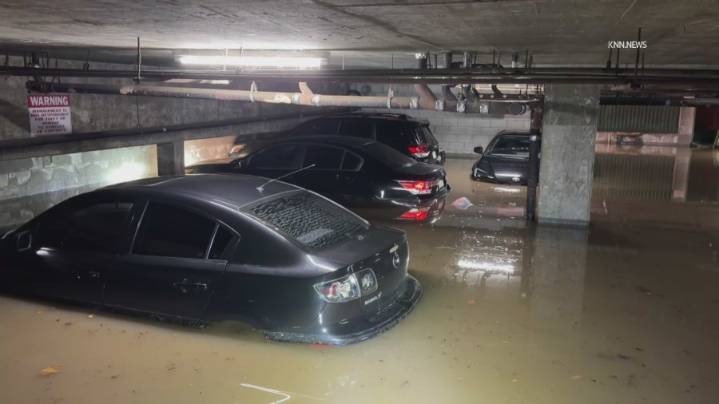 Heavy rain floods underground Palms garage, submerging a dozen cars