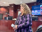 Adoptive mother charged after allegedly sitting on 11