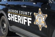 Police say a man shot a teen through his door near Jackson. Now both are facing charges.