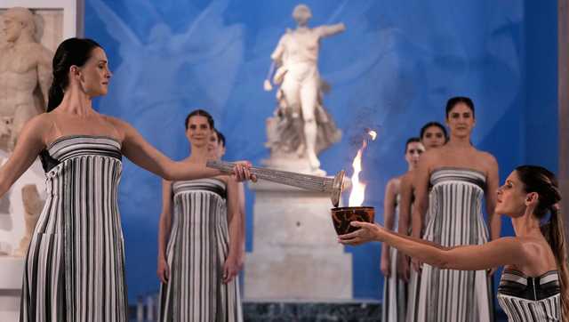 Under a cloud, the Olympic flame begins its journey to the Milan Cortina Winter Olympics