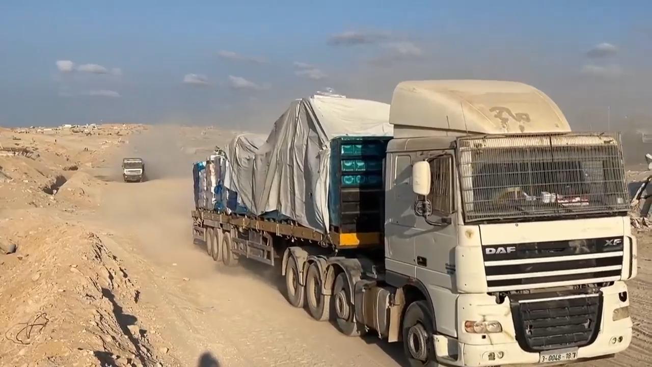 Trucks bearing aid seen arriving into Gaza through the Zikim border crossing