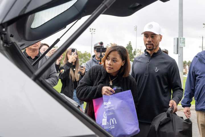Mookie Betts, his wife Brianna, and family joined volunteers giving turkeys to 750 families