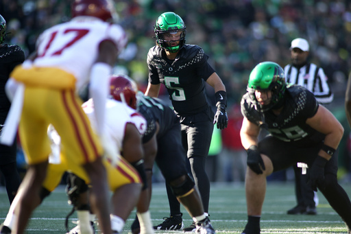Moore throws 2 TD passes and No. 6 Oregon derails No. 16 USC's CFP hopes with a 42