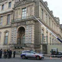 Woman charged over Louvre heist tears up in court