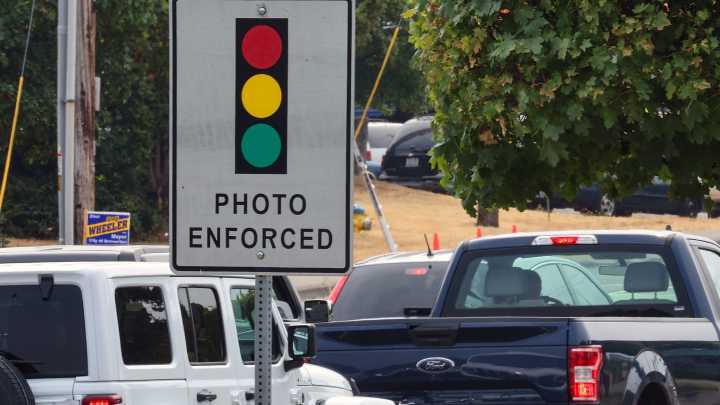 A friend driving my car got a red light ticket. Who pays the fine in GA?