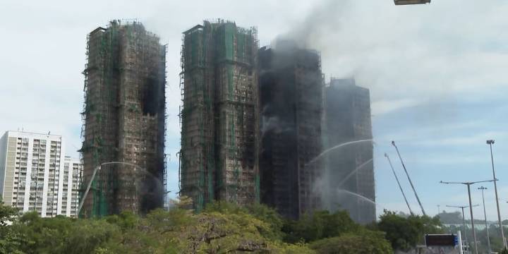 At least 65 dead as Hong Kong firefighters battle burning towers for a second day