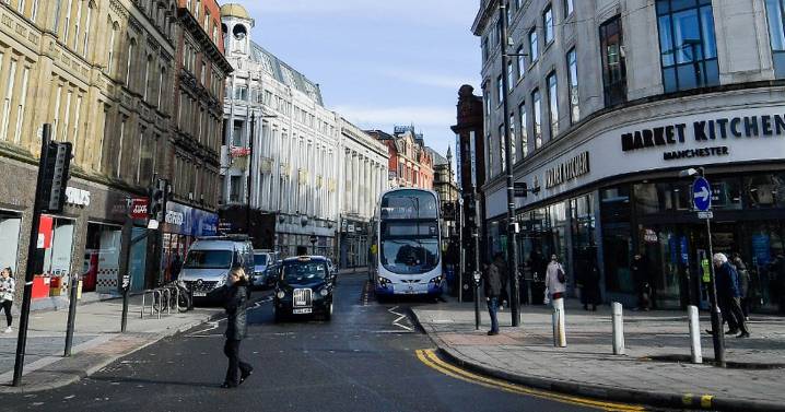 Woman 'pushed into road' by unknown man in Manchester city centre