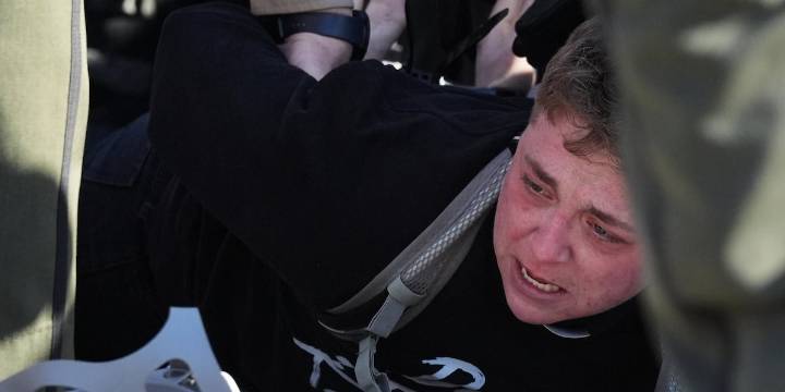 Protesters arrested, officers injured in clash outside Chicago