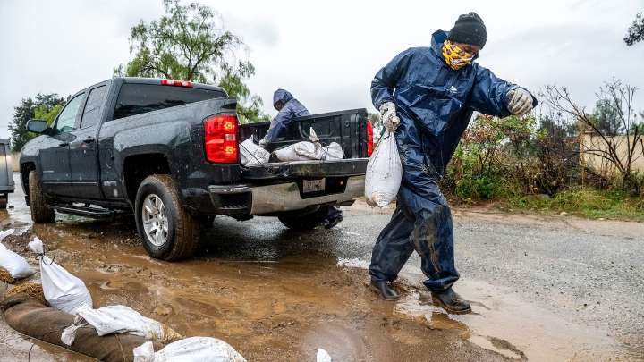 Atmospheric river hits Southern California with risks of flash floods and deaths on stormy seas