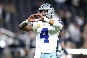 Grieving Cowboys remember Kneeland, defeat Raiders