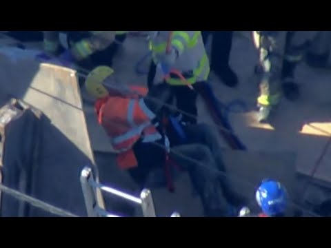 Video shows moment construction worker lifted to safety after trench collapse