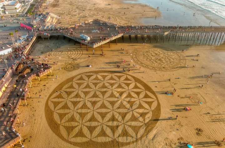 Central Coast beach covered with intricate sand art murals