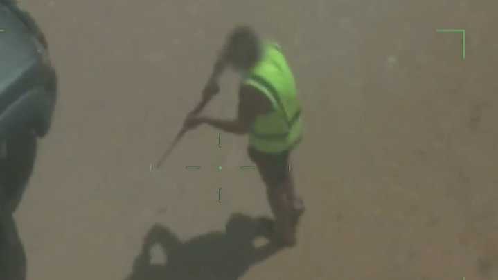 Moment former bikie fires rifle towards police caught on camera