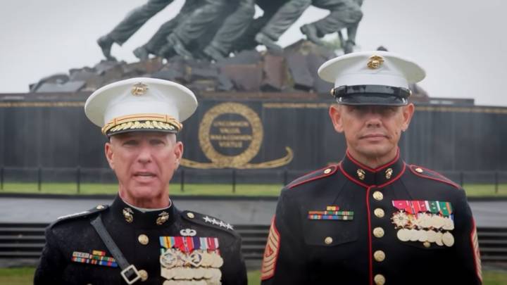 Top Marines stand in a rain storm to wish the Corps a happy birthday