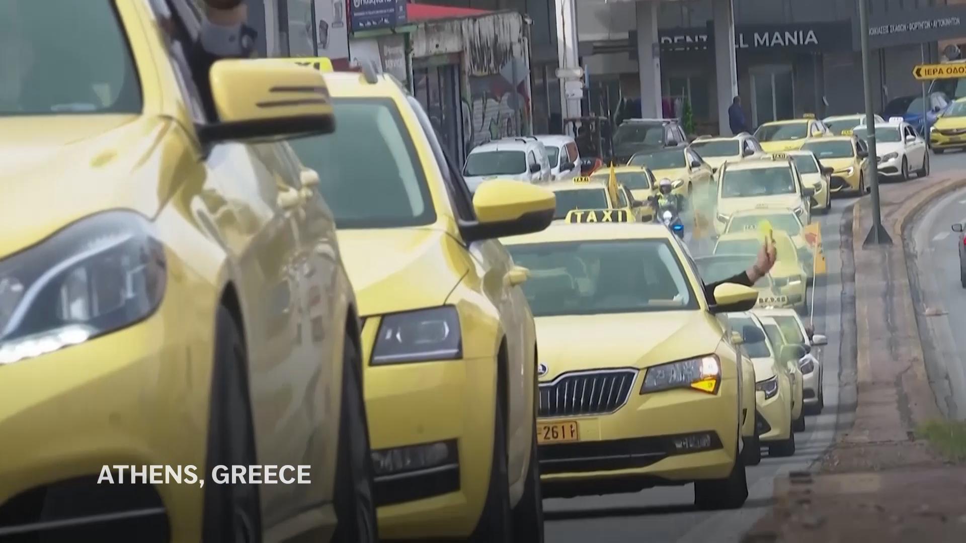 Parade of yellow taxis through Athens as drivers begin 48