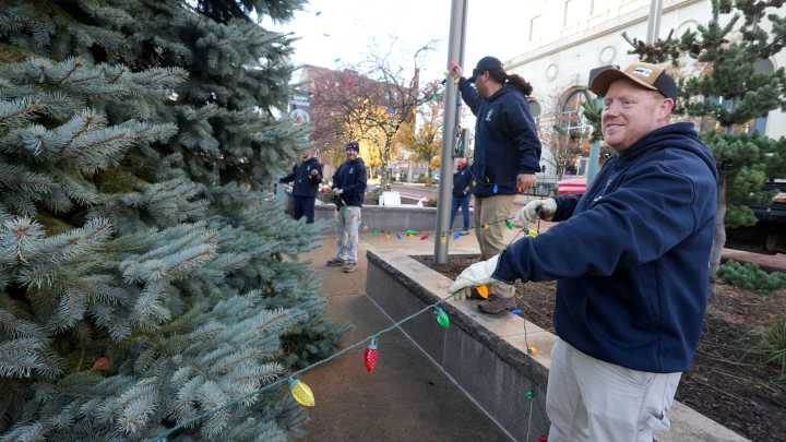 IBEW volunteers put lights on Christmas tree in downtown Canton