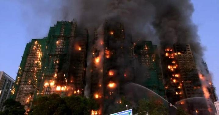 At least 94 dead as Hong Kong firefighters battle burning towers for a second day