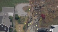Water main break floods streets, causes neighborhood road to buckle