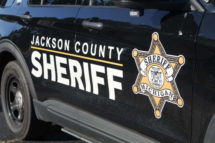 Police say a man shot a teen through his door near Jackson. Now both are facing charges.