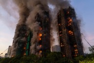 13 people killed in fire engulfing Hong Kong high-rise residential buildings, fire services say