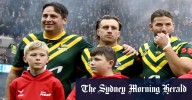 Notorious pitch invader stands arm-in-arm with Kangaroos during anthem