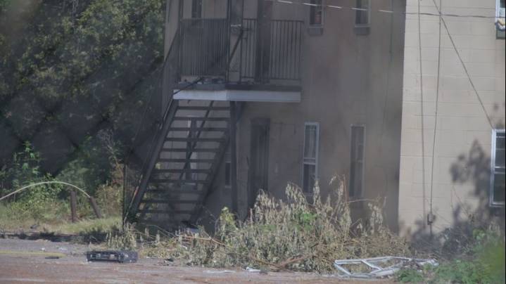 Standing water, trash affecting home surrounded by blight