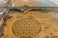 Central Coast beach covered with intricate sand art murals