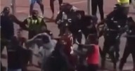 Chaotic football brawl sees 17 sent off in violent scenes as police fire tear gas