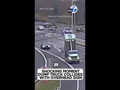 Shocking moment dump truck collides with overhead signage