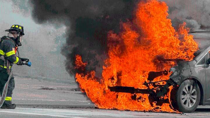 PHOTOS: School van catches fire in intersection with people trapped inside